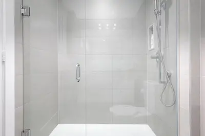 a white bathroom with a shower and a toilet at Perfect Condo Sleeps 4 Across from Cn Tower! in Toronto
