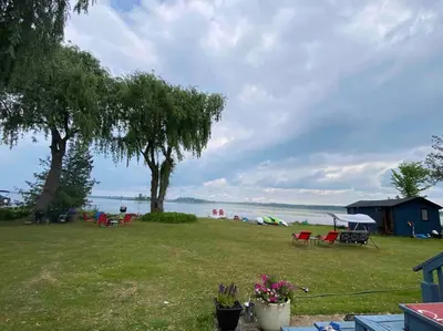 a park with a view of the water and a beach at Sunrise net cottage in Kawartha Lakes