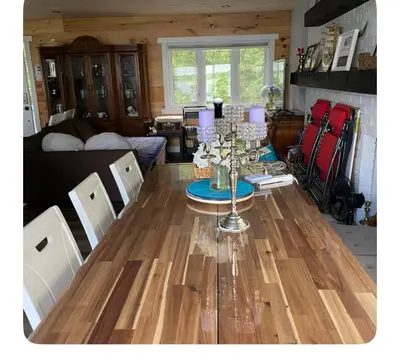 a living room with a table and a couch at Sunrise net cottage in Kawartha Lakes