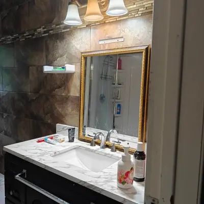 a bathroom with a sink and a mirror at Lina's Place1 in St. Catharines