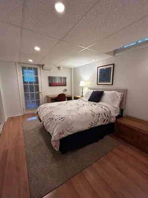 a bedroom with a large bed and a window at Maya Bed and Breakfast in Port Perry