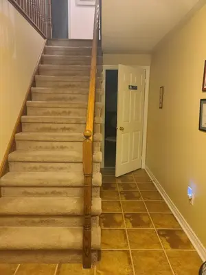 a stairway in a home with a white door at Maya Bed and Breakfast in Port Perry