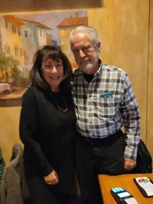 a woman and an older man standing next to a table at Maya Bed and Breakfast in Port Perry