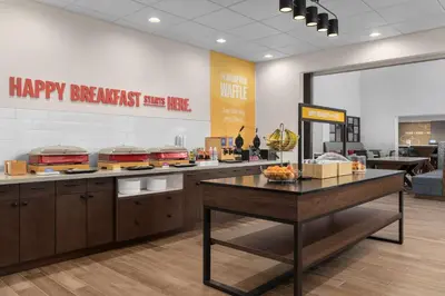 a restaurant with a counter with some food on it at Hampton Inn & Suites Orangeville, On in Orangeville