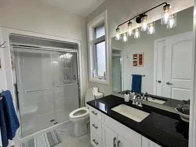 a bathroom with a shower and a sink and a toilet at Luxury Home 2 mins drive to Saugeen Shores beach in Port Elgin