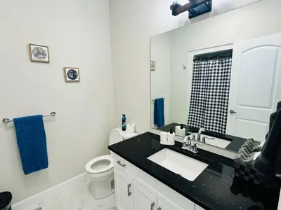 a bathroom with a sink and a toilet and a mirror at Luxury Home 2 mins drive to Saugeen Shores beach in Port Elgin