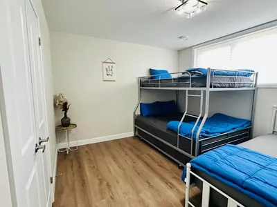 a bedroom with two bunk beds with blue pillows at Luxury Home 2 mins drive to Saugeen Shores beach in Port Elgin