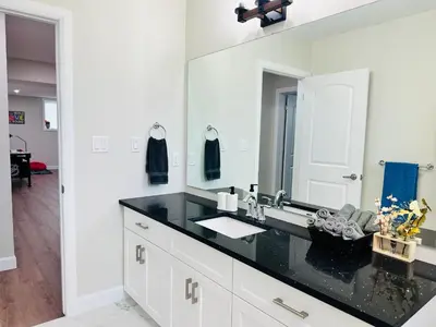 a bathroom with a sink and a mirror at Luxury Home 2 mins drive to Saugeen Shores beach in Port Elgin