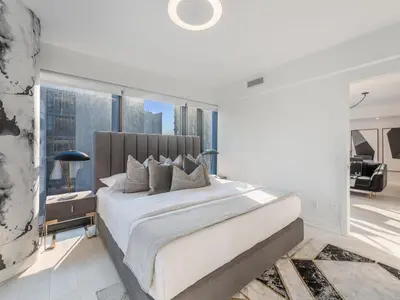a bedroom with a large bed and a large window at Hazelton Suites - Yorkville - Indoor Pool & Hot Tub in Toronto