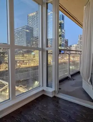 an empty room with large windows with a view of a city at Downtown City View Escape with Free Parking in Toronto