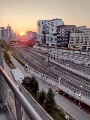 a view of a city with train tracks and buildings at Downtown City View Escape with Free Parking in Toronto