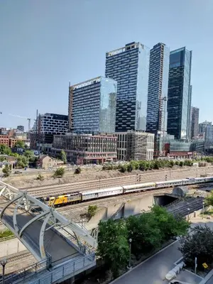 a train on a track in a city with tall buildings at Downtown City View Escape with Free Parking in Toronto