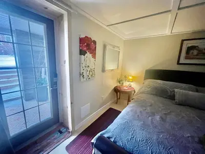 a bedroom with a bed and a large window at Cobourg Country Home - 10 Minutes From Cobourg Beach! in Cobourg