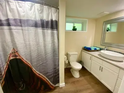 a bathroom with a shower and a toilet and a sink at Cobourg Country Home - 10 Minutes From Cobourg Beach! in Cobourg