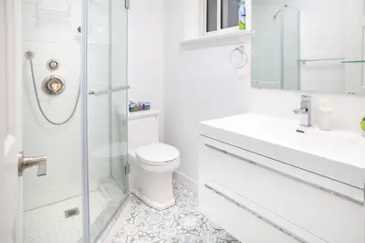 a white bathroom with a toilet and a shower at Stunning Vacation Home North of Toronto in Richmond Hill