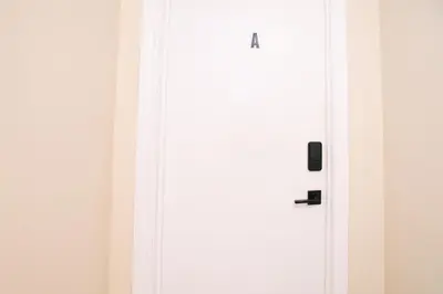 a white door with a black handle in a room at Stunning Vacation Home North of Toronto in Richmond Hill