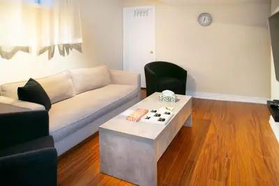 a living room with a couch and a table at Stunning Vacation Home North of Toronto in Richmond Hill
