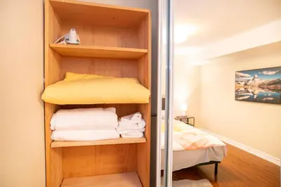 a room with a closet with towels and a bed at Stunning Vacation Home North of Toronto in Richmond Hill
