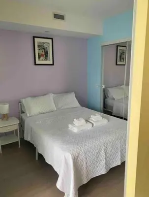 a bedroom with a bed with towels on it at Bright 1BR w Large Terrace - Entertainment District in Toronto