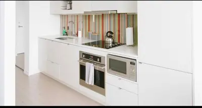 a white kitchen with a stove and a sink at Bright 1BR w Large Terrace - Entertainment District in Toronto