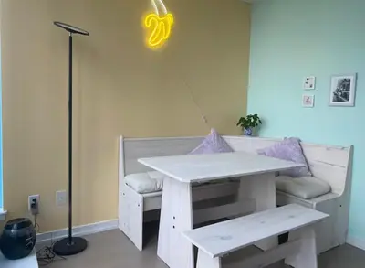 a table and a bench with a light in a room at Bright 1BR w Large Terrace - Entertainment District in Toronto