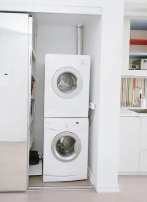 a washer and dryer in a white room at Bright 1BR w Large Terrace - Entertainment District in Toronto