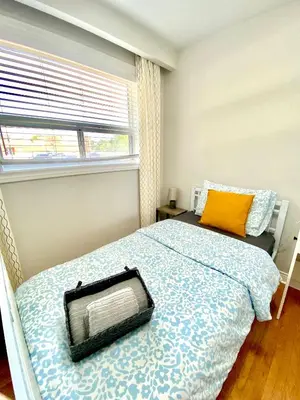 a bedroom with a bed and a window at Sunny House - Main Floor, Free parking, in Toronto in Toronto