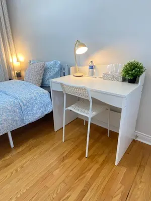 a white desk with a lamp and a bed at Sunny House - Main Floor, Free parking, in Toronto in Toronto