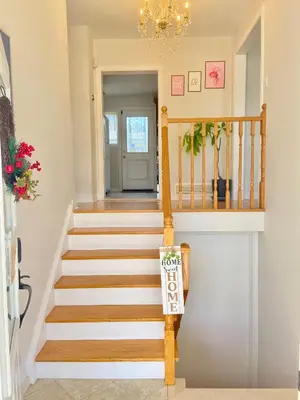 a staircase in a home with a chandelier at Sunny House - Main Floor, Free parking, in Toronto in Toronto