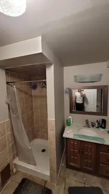 a person taking a picture of a bathroom with a shower at 3 Room Set for Up to 8 people- 10 minutes from Kitchener Airport, Walking to Transit in Kitchener