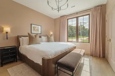 a bedroom with a large bed and a window at The Penrose Suites in Saint Marys