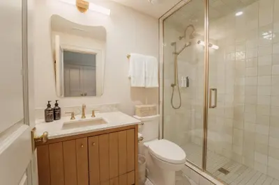 a bathroom with a toilet sink and a shower at The Penrose Suites in Saint Marys