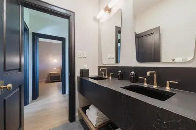 a bathroom with two sinks and a mirror at The Penrose Suites in Saint Marys