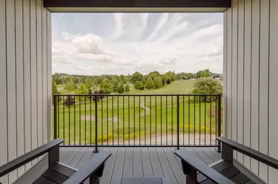 a porch with benches and a view of a field at The Penrose Suites in Saint Marys