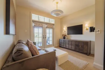 a living room with a couch and a flat screen tv at The Penrose Suites in Saint Marys