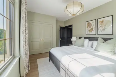 a bedroom with a large bed and a window at The Penrose Suites in Saint Marys