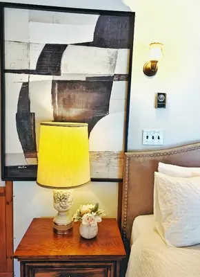 a lamp on a table next to a bed at Walk to Lake - Old Town Retreat in Niagara on the Lake