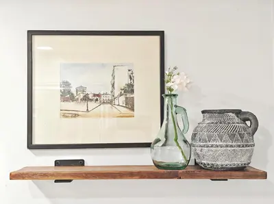 a vase and a pitcher on a shelf with a picture at Walk to Lake - Old Town Retreat in Niagara on the Lake