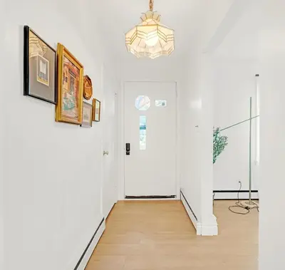 a hallway with white walls and a white door at Walk to Lake - Old Town Retreat in Niagara on the Lake