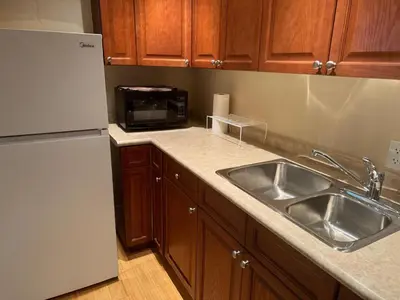 a kitchen with a sink and a refrigerator at Luxury Apartment Living in Mississauga