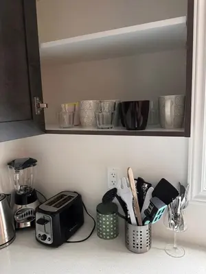 a kitchen counter with a toaster and other kitchen utensils at Cozy 5 bedrooms & 5 bathrooms House in Tottenham