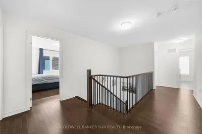 a white room with a staircase and a bedroom at Cozy 5 bedrooms & 5 bathrooms House in Tottenham