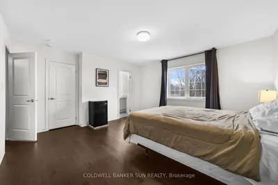a bedroom with a bed and a television in it at Cozy 5 bedrooms & 5 bathrooms House in Tottenham
