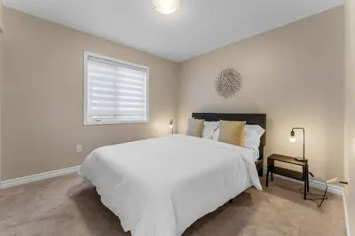 a bedroom with a large white bed and a window at Spacious Family Getaway Near Nature & Dining in Cambridge