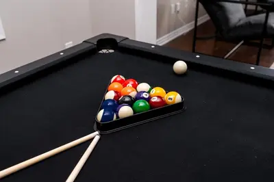 a pool table with billiard balls and cues on it at Spacious Family Getaway Near Nature & Dining in Cambridge