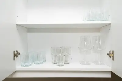 a shelf filled with glasses on a wall at Spacious Family Getaway Near Nature & Dining in Cambridge