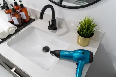 a kitchen sink with a blow dryer on it at Modern 3 Bdr Homeapt Mins To Notlwineriesfalls in St. Catharines