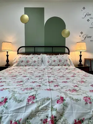 a bedroom with a large bed with flowers on it at Private Room Near Airport K3 in Mississauga