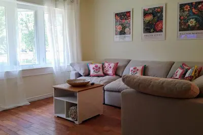 a living room with a couch and a table at Birdsong Bungalow in Port Dover