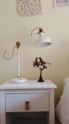 a table with a lamp and a toy on it at Birdsong Bungalow in Port Dover
